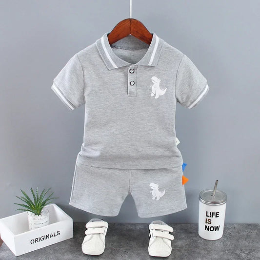 Get your little one ready for summer in style with our Summer Toddler Boys Dinosaur Turn-down Collar Top-Shorts!