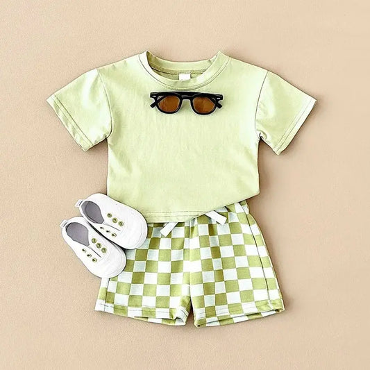 Keep your little one comfy this summer with this playful Summer Toddler Boys Solid Color T-shirt Plaid Shorts.