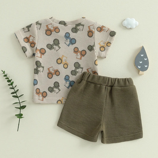 Add some playful charm to your little one's wardrobe with our Summer Toddler Boys Tractor Print T-shirt-Solid Shorts!