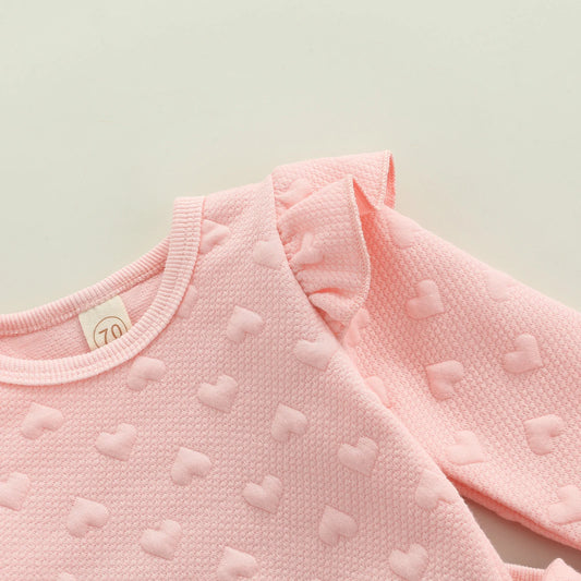 Dress your little one in cozy cuteness with this pink Newborn Girls Autumn Long Sleeve Heart Printed Sweatsuit. Made from a soft, breathable cotton-polyester blend