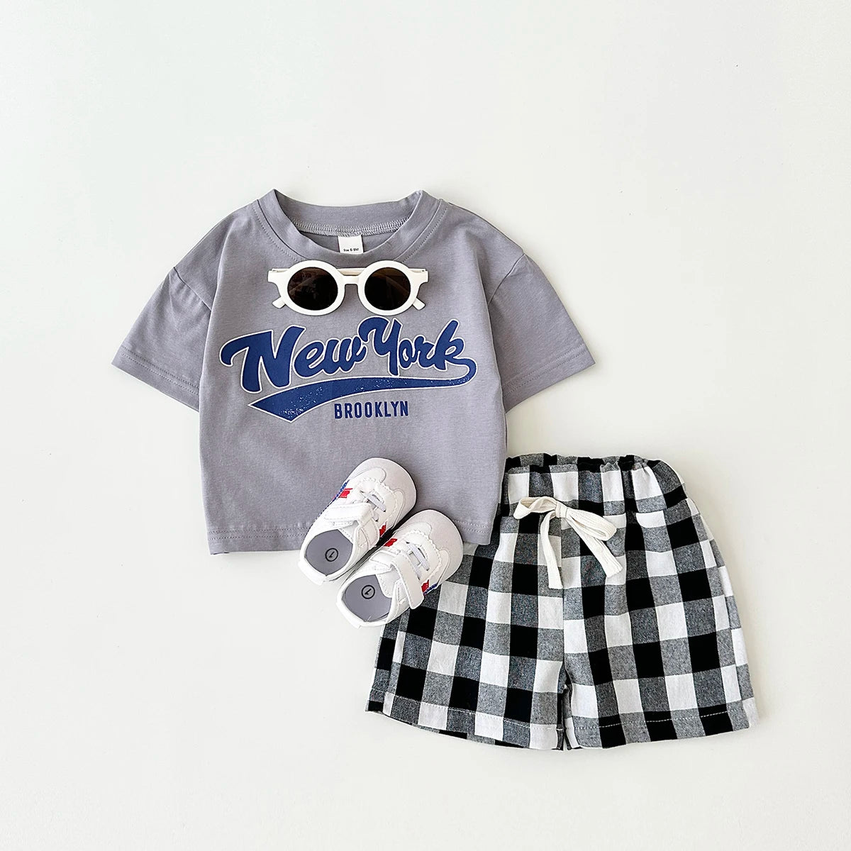 Dress your little guy in style with our Summer Newborn Boys Short Sleeved T-shirt and Checkered Shorts set!