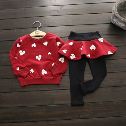 Dress your little sweetheart in this adorable Toddler Girls Autumn Heart Sweatshirt-Skirt Leggings featuring a heart-print sweatshirt, skirt, and leggings made from soft polyester. 