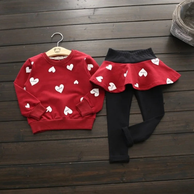 Dress your little sweetheart in this adorable Toddler Girls Autumn Heart Sweatshirt-Skirt Leggings featuring a heart-print sweatshirt, skirt, and leggings made from soft polyester. 