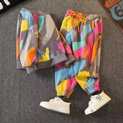 Dress your little one in this playful Toddler Boys Fashion Graffiti Sweater and Pants 2PC Set featuring a colorful graffiti print sweater and matching pants. 