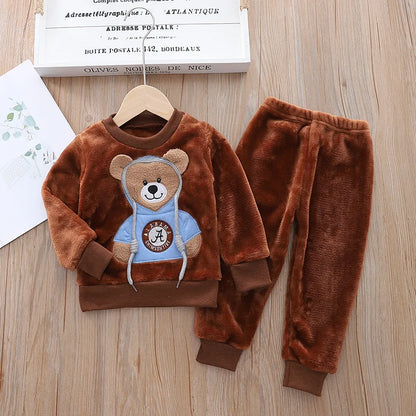 This cozy hooded tracksuit is perfect for your little one during the winter months. Made with cotton and polyester materials, it's soft and warm.