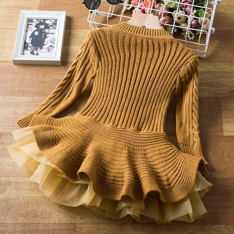 Keep your little one cozy and cute in this Girls Winter Long Sleeve Knitted Sweater Dress! Made from a comfy blend of cotton, polyester, and viscose, 