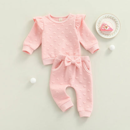 Dress your little one in cozy cuteness with this pink Newborn Girls Autumn Long Sleeve Heart Printed Sweatsuit. Made from a soft, breathable cotton-polyester blend