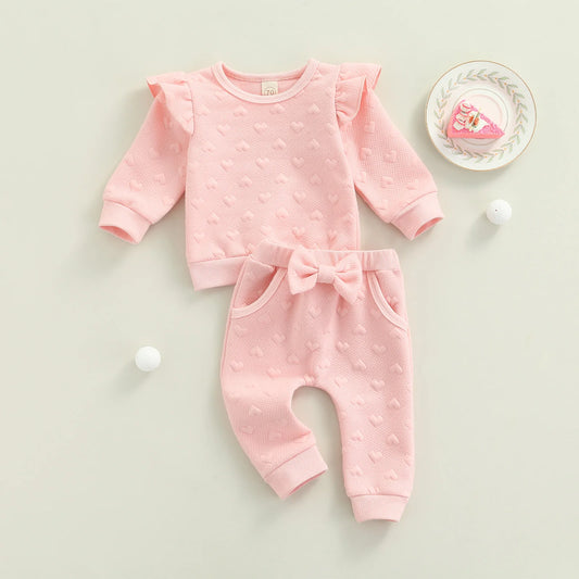 Dress your little one in cozy cuteness with this pink Newborn Girls Autumn Long Sleeve Heart Printed Sweatsuit. Made from a soft, breathable cotton-polyester blend