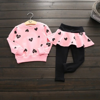 Dress your little sweetheart in this adorable Toddler Girls Autumn Heart Sweatshirt-Skirt Leggings featuring a heart-print sweatshirt, skirt, and leggings made from soft polyester. 