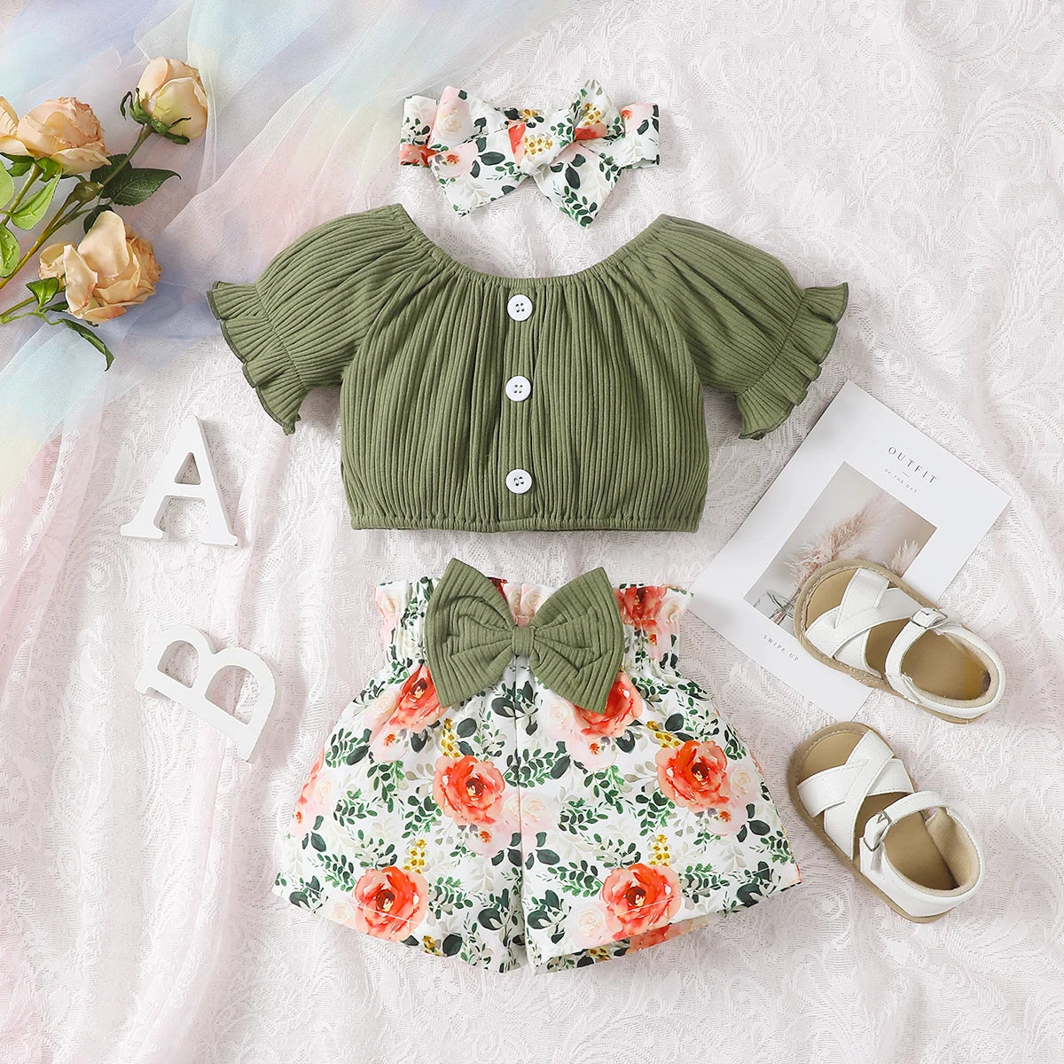 Get your little girl ready for summer with this playful set! Featuring a short-sleeved top, headscarf, and floral bow shorts.