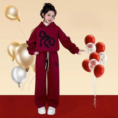 Cozy up this winter with a Girls Fleece-Lined Ribbon Hoodie Top & Pants that won't judge you for wearing it three days in a row. 