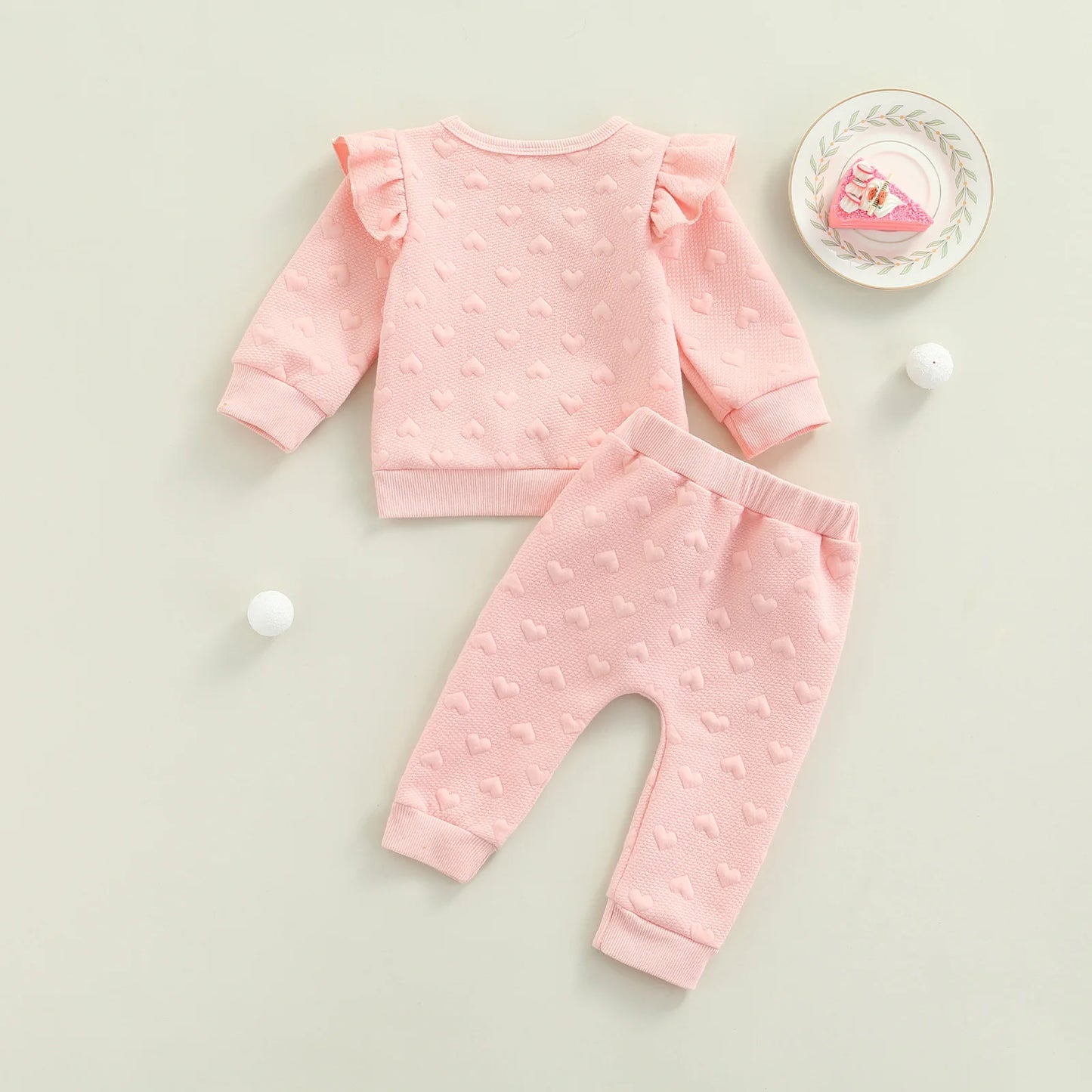 Dress your little one in cozy cuteness with this pink Newborn Girls Autumn Long Sleeve Heart Printed Sweatsuit. Made from a soft, breathable cotton-polyester blend