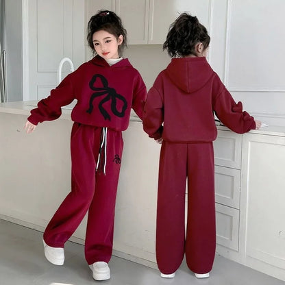Cozy up this winter with a Girls Fleece-Lined Ribbon Hoodie Top & Pants that won't judge you for wearing it three days in a row. 