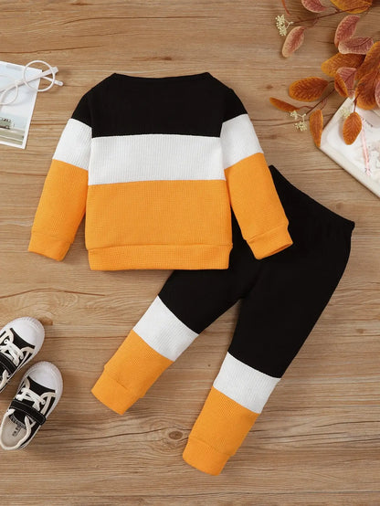Keep your little one cozy and stylish this autumn with this playful Toddler Boys Autumn Color Block Top and Pants. Made from soft cotton and polyester blend