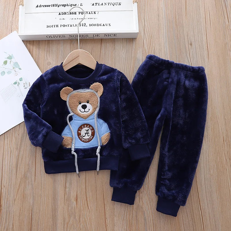 This cozy hooded tracksuit is perfect for your little one during the winter months. Made with cotton and polyester materials, it's soft and warm.