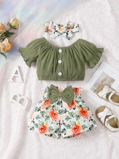 Get your little girl ready for summer with this playful set! Featuring a short-sleeved top, headscarf, and floral bow shorts.