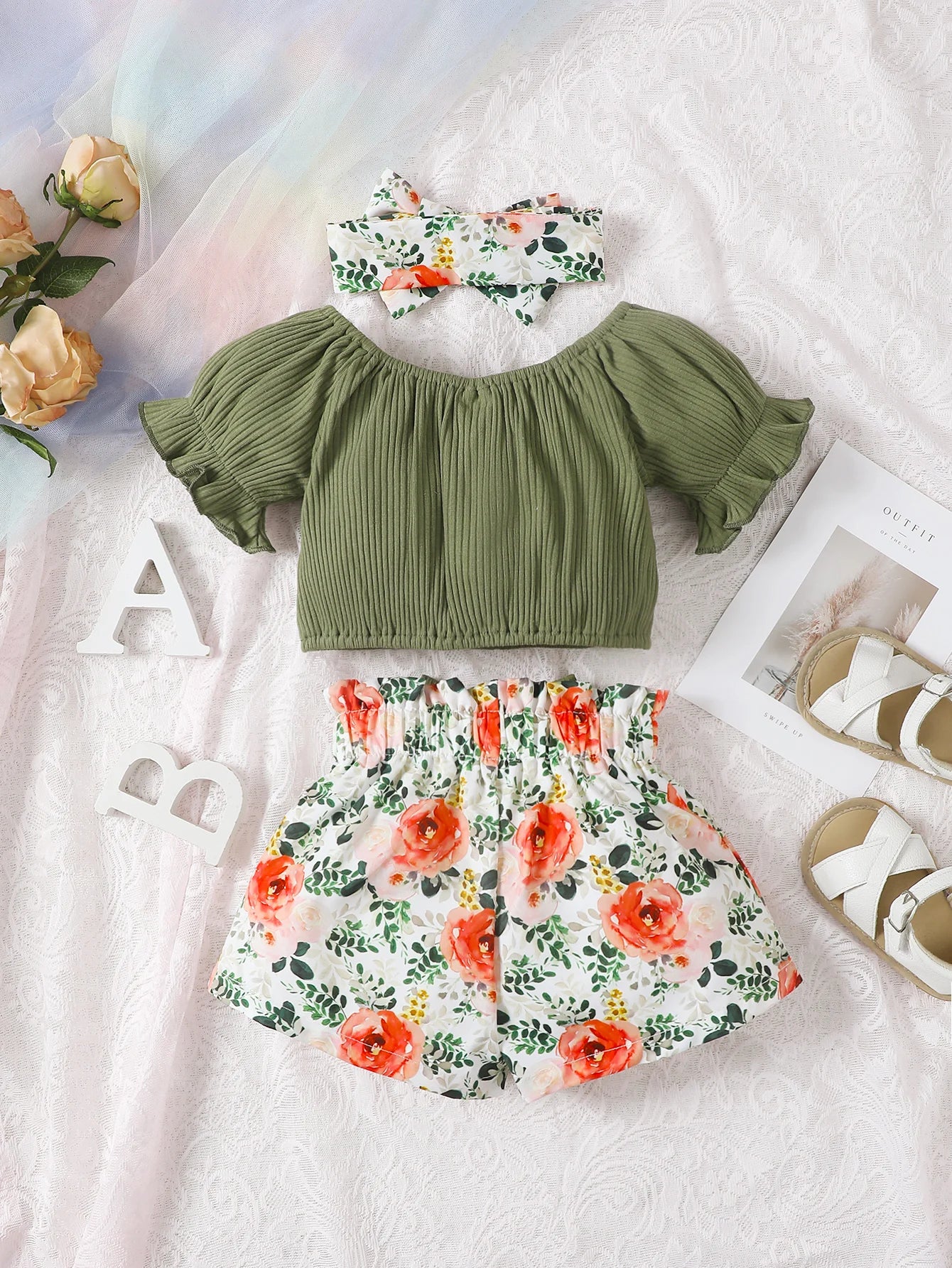 Get your little girl ready for summer with this playful set! Featuring a short-sleeved top, headscarf, and floral bow shorts.