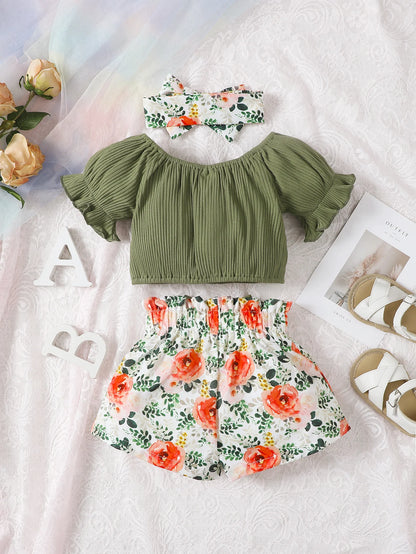 Get your little girl ready for summer with this playful set! Featuring a short-sleeved top, headscarf, and floral bow shorts.