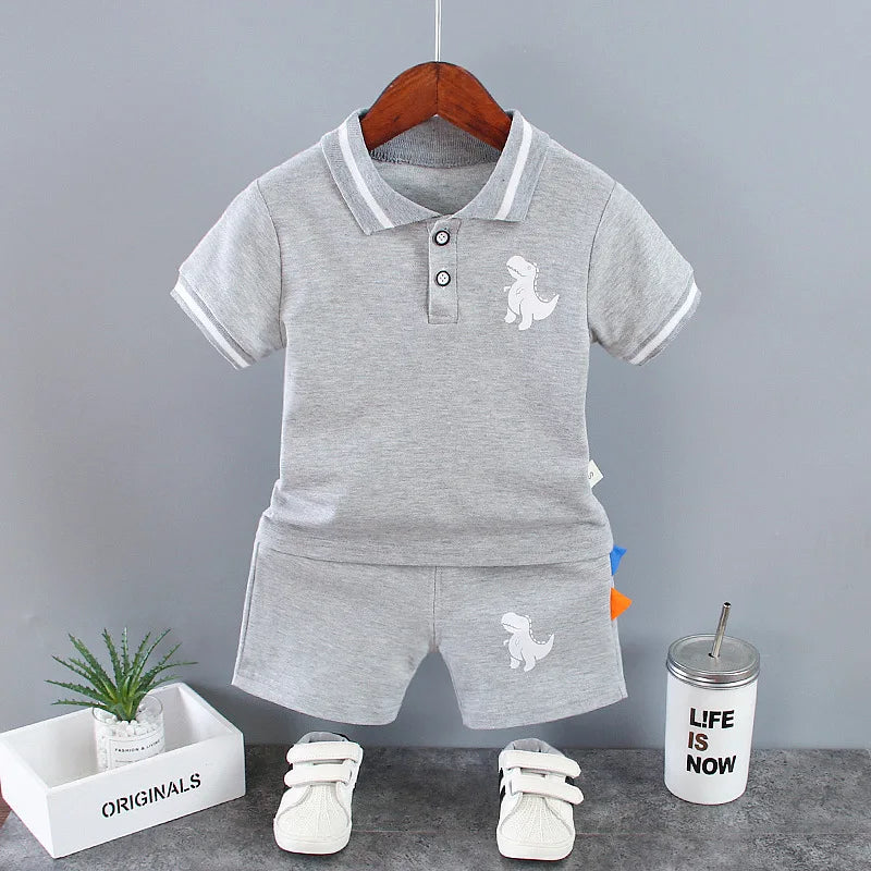 Get your little one ready for the summer with this adorable Summer Toddler Boys Dinosaur Print 2PC Set.