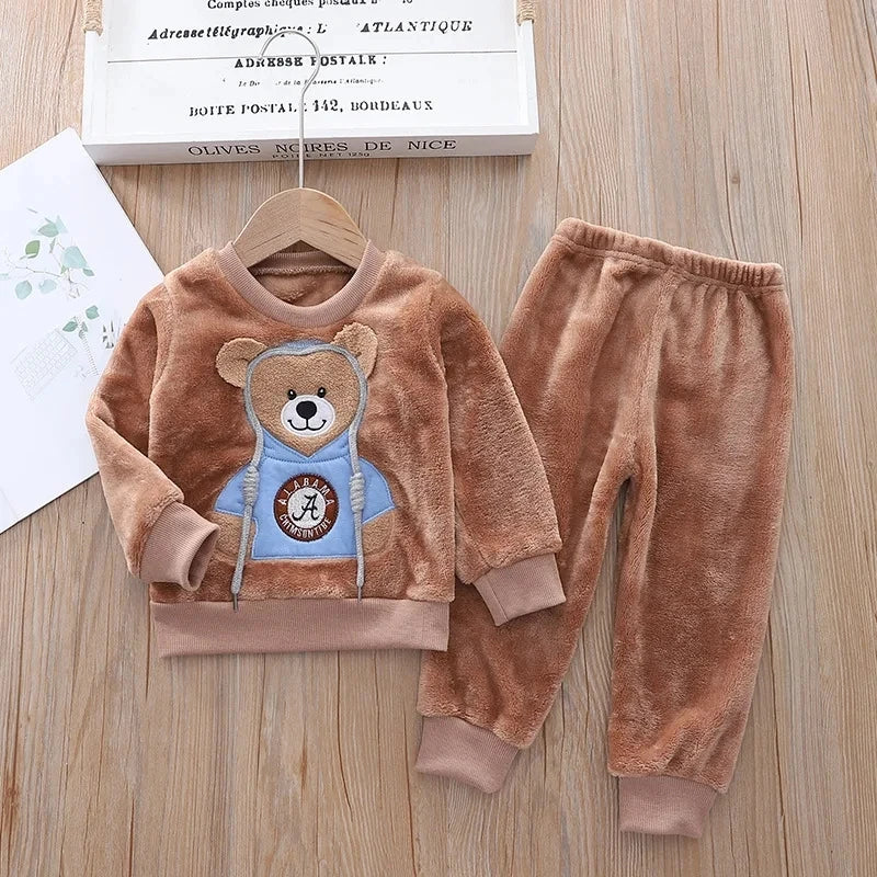 This cozy hooded tracksuit is perfect for your little one during the winter months. Made with cotton and polyester materials, it's soft and warm.