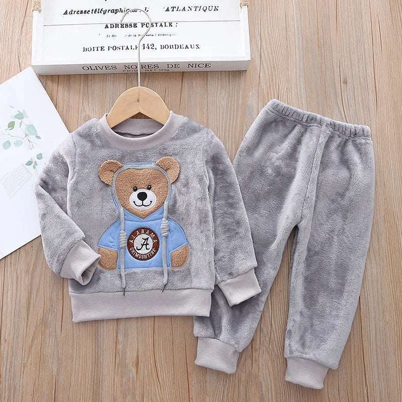 This cozy hooded tracksuit is perfect for your little one during the winter months. Made with cotton and polyester materials, it's soft and warm.