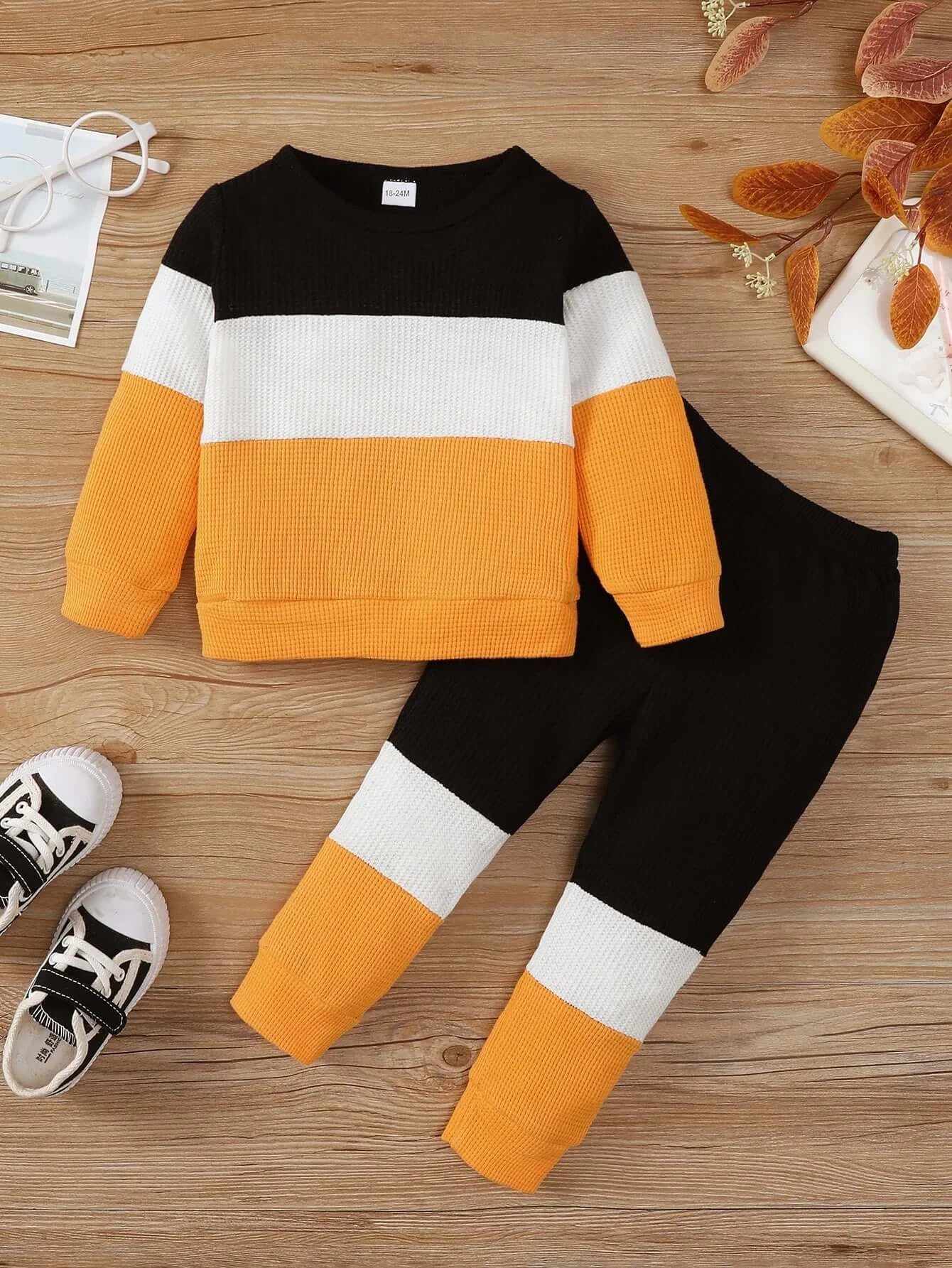 Keep your little one cozy and stylish this autumn with this playful Toddler Boys Autumn Color Block Top and Pants. Made from soft cotton and polyester blend